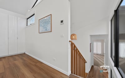 Bright and open foyer with modern design, leading to spacious living areas and stylish staircase.