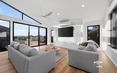 Bright and airy living space featuring large windows that showcase stunning outdoor views and modern design.
