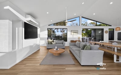 Bright and airy living space with large windows offering stunning views and seamless indoor-outdoor flow.