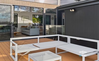 Bright outdoor living space seamlessly connects to an inviting open-plan interior, perfect for entertaining and relaxation.
