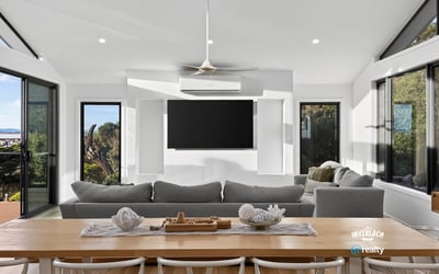 Bright, open-plan living area with panoramic views, featuring large windows and a modern, minimalist design.