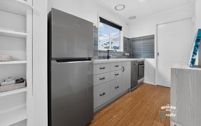 Modern kitchen featuring sleek appliances, ample storage, and a bright, inviting atmosphere perfect for cooking.