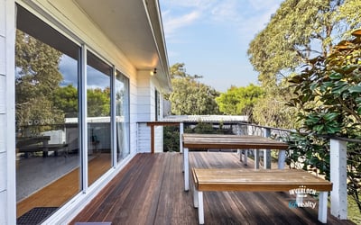Enjoy outdoor living on this spacious deck, surrounded by lush greenery and natural beauty.