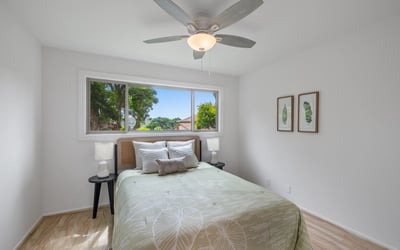 Bright and inviting bedroom featuring large windows, modern fixtures, and thoughtful decor for comfort and tranquility.