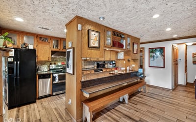 This inviting kitchen features ample cabinetry, modern appliances, and a cozy breakfast bar for casual dining.