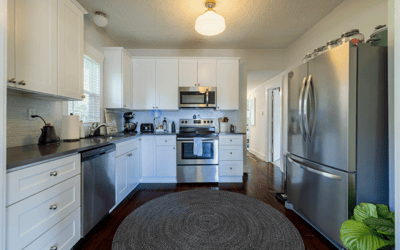 Bright, functional kitchen featuring stainless steel appliances, ample storage, and a cozy dining area.