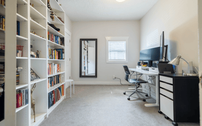 Bright and functional office space featuring built-in bookshelves and ample room for workspace or study.