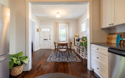 Bright and inviting open-concept space, featuring a modern kitchen leading to a cozy dining area.