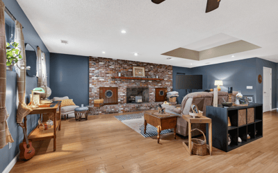 Spacious living area featuring a brick fireplace, modern amenities, and ample natural light for relaxation.