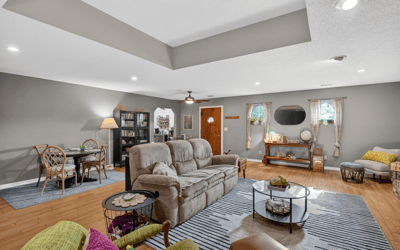 Spacious living area features modern decor, ample natural light, and versatile seating for relaxation or gatherings.