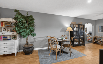 Bright and inviting living space featuring a cozy dining area and rich hardwood flooring throughout.