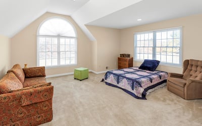 Bonus Room features an attractive arch-top double window and a high ceiling. Two extensive storage spaces are accessed via doors near room entry.