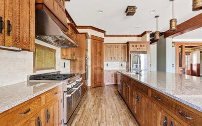 Gourmet kitchen equipped with professional appliances, custom cabinetry, and expansive prep space. Designed for culinary enthusiasts, this Phoenix home offers elevated finishes and everyday practicality.