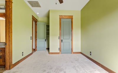 Well-proportioned bedroom with custom trim details, neutral tones, and inviting natural light. Ideal for flexible living arrangements or guest accommodations.
