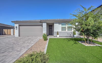 Crisp lines, designer stone accents, and easy-care desert landscaping define this newer construction Peoria home s refined curb appeal.