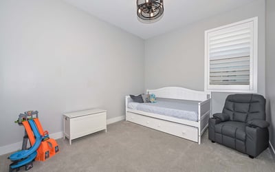 A bright and neutral bedroom with playful touches and room to grow. Use it as a nursery, guest space, or stylish home office.