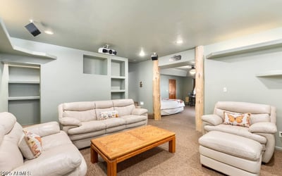 Lower-level living space with built-ins and open layout, ideal for lounging, hobbies, or overflow entertaining.