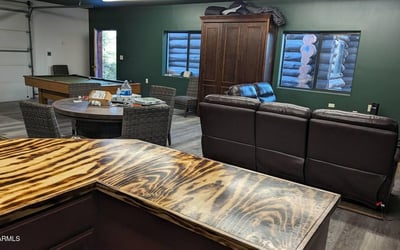 Inviting entertainment room featuring a handcrafted bar, open layout, and space for games or lounging. Designed for comfort and function, this area complements the home s rustic Prescott mountain style.