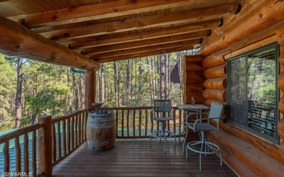 Covered deck featuring seating and forest views. Perfect for morning coffee or evening relaxation, this outdoor space enhances indoor-outdoor living in the Prescott mountains.