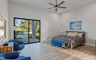 Elegant main bedroom with sliding doors to patio and pool access combines indoor comfort with outdoor Scottsdale living.