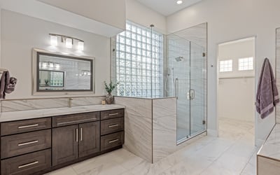 A spa-style primary bath with expanded vanity, glass shower, and modern finishes elevates this Scottsdale home.