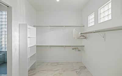 Oversized closet with built-in shelving and storage maximizes organization in the Scottsdale main suite.