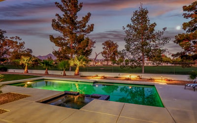 The pool glows beautifully at dusk, creating a serene and inviting atmosphere for evening entertaining or quiet relaxation.