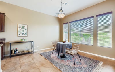 A light-filled breakfast nook offers views of the landscaped backyard, creating the perfect spot for everyday dining.