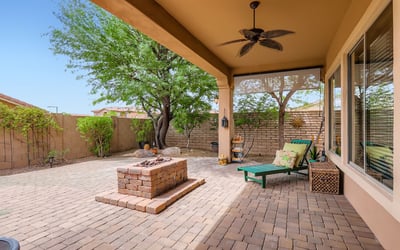 Relax on the expansive patio with a built-in gas firepit and paver design, ideal for Arizona evenings and entertaining guests.