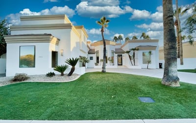 Expansive front lawn bordered by tropical palms and crisp architecture. A peaceful, resort-like welcome every time you arrive home.
