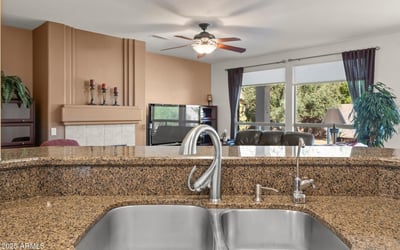 Entertain in style from this kitchen s granite island and dual sinks. The open concept keeps everyone connected and enhances flow throughout the home.