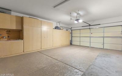 Extended garage with built-in cabinetry and workbench area, perfect for hobbyists, extra storage, or home projects.