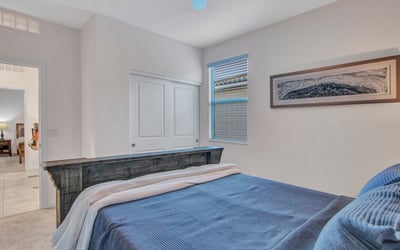 A light-filled guest room with modern touches, dual windows, and generous storage perfect for restful living in Litchfield Park.
