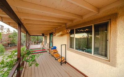 With extended shade and space for seating, this porch offers expansive forest and mountain views. A refreshing retreat surrounded by desert greenery.