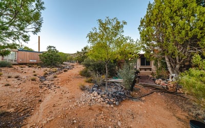 A rugged desert path winds through native plants and open terrain, demonstrating the property s generous land and serene surroundings in Hackberry.