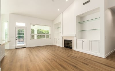 Comfortable family room with a stylish fireplace and built-in shelving accents. This inviting Scottsdale space is perfect for relaxing evenings or entertaining guests in a warm, welcoming setting.