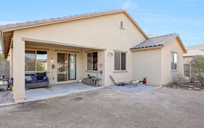 Covered patio providing shaded outdoor living space with room for seating and entertaining just steps from the interior.
