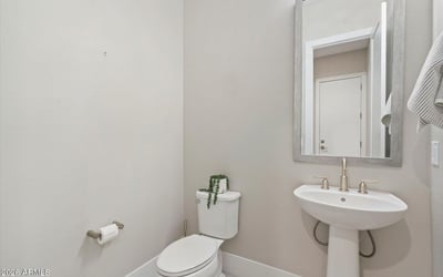 Guest powder bathroom with pedestal sink and stylish finishes, conveniently located for visitors and daily use.