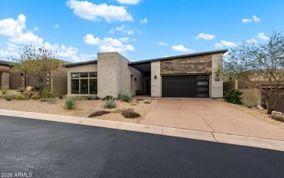 Contemporary Scottsdale exterior showcasing refined materials, clean lines, and desert-inspired landscaping. A striking example of modern luxury design in a gated community.