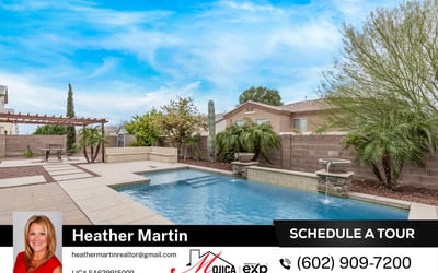 The backyard pool with dual water features creates a tranquil setting perfect for relaxation. Surrounded by pavers and desert landscaping, this Glendale property offers a stylish and functional outdoor retreat.