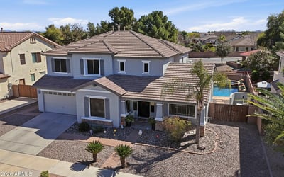 Drone perspective highlighting the beautiful Queen Creek home with a private pool and spa backyard, desert landscaping, and spacious lot within the desirable Cortina neighborhood.