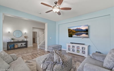 View from the living room toward the open entryway, showcasing the spacious layout, tall ceilings, and modern finishes throughout the home.