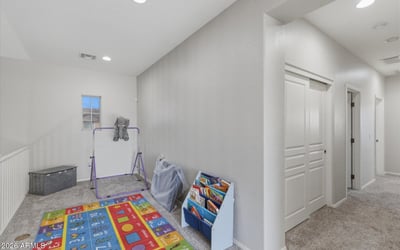 Upstairs loft and hallway connecting to bedrooms and bathrooms, providing additional living space perfect for family activities.