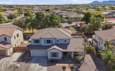 Aerial photo highlighting the full property footprint, landscaped yard, and surrounding neighborhood streets in this desirable Queen Creek location.