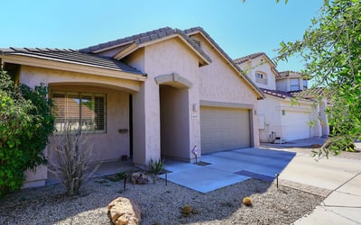 Angled exterior view highlighting the home s design, landscaping, and driveway. This Phoenix property offers appealing curb presence.