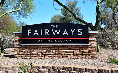 Entrance monument for The Fairways at The Legacy with desert landscaping. This Phoenix community is known for its golf course access and maintained grounds.