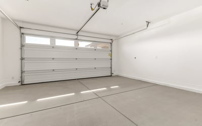 Two-car garage featuring clean finishes, automatic opener, and space for storage or workshop setup in this Peoria home.