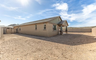 Wide backyard with privacy fencing and distant mountain views, offering a peaceful setting and room to customize.