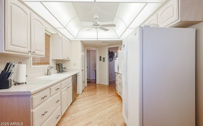 Functional kitchen with white cabinets, generous counters, and updated appliances, designed for efficient cooking and entertaining.