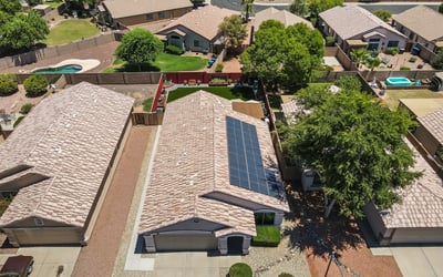 Aerial perspective showcasing solar panels, roof condition, and backyard space. Energy-efficient features add value and long-term savings.